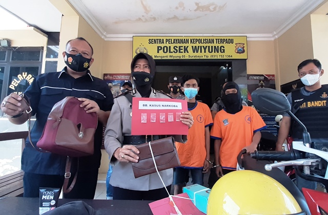 BARANG BUKTI: Kapolsek Wiyung Kompol Parmiatun menunjukkan barang bukti narkoba, ponsel, motor Honda Beat sarana, uang tunai, ATM, SIM, dan buku tabungan. (MAHRUS/RADAR SURABAYA)