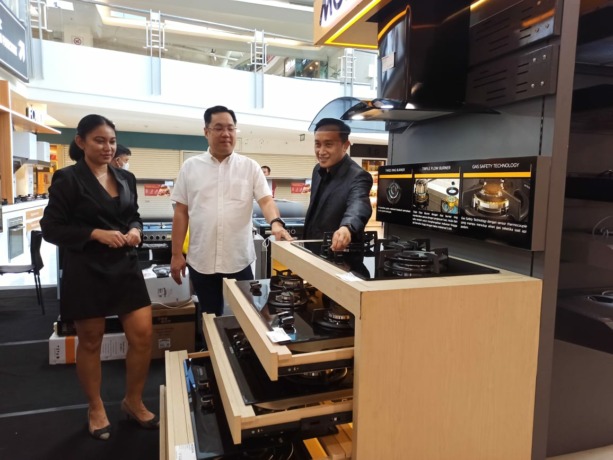 PASAR MEMBAIK: Poedji Horixon (tengah) dan Albertus Sapta (kanan) menjelaskan salah satu produk unggulan Modena. (M. Afiq Firdaus/Radar Surabaya)