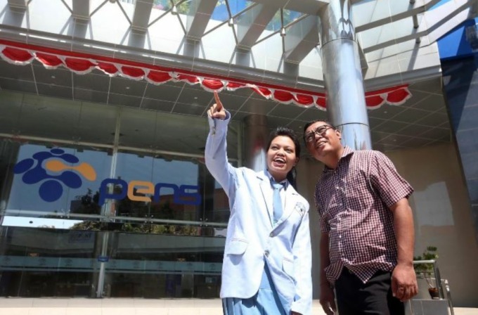 Putri Naomi Tatiwakeng (19), penerima Beasiswa Gojek dari Politeknik Elektronika Negeri Surabaya (PENS) bersama ayahnya yang juga mitra GoCar Surabaya, Hengky Tatiwakeng. (ISTIMEWA)