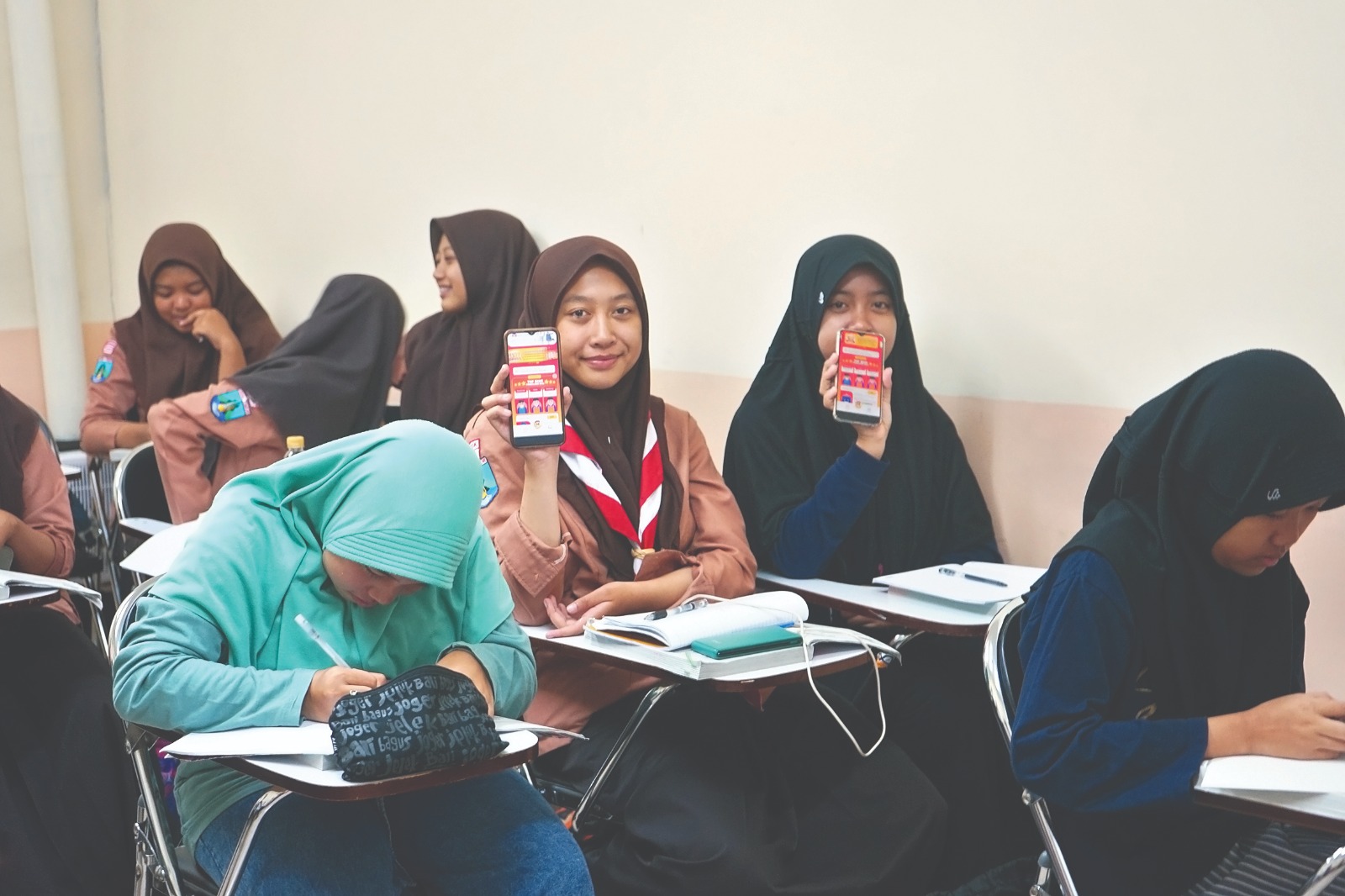 DARING: Dua siswa yang ikut lembaga bimbel menunjukan aplikasi yang berisi modul dan buku saku yang bisa di-download.
