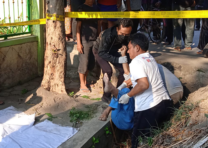 EVAKUASI: Tim Inafis Polres Kediri mengangkat jasad pria yang ditemukan di selokan jalan raya Gurah-Pare kemarin pagi.