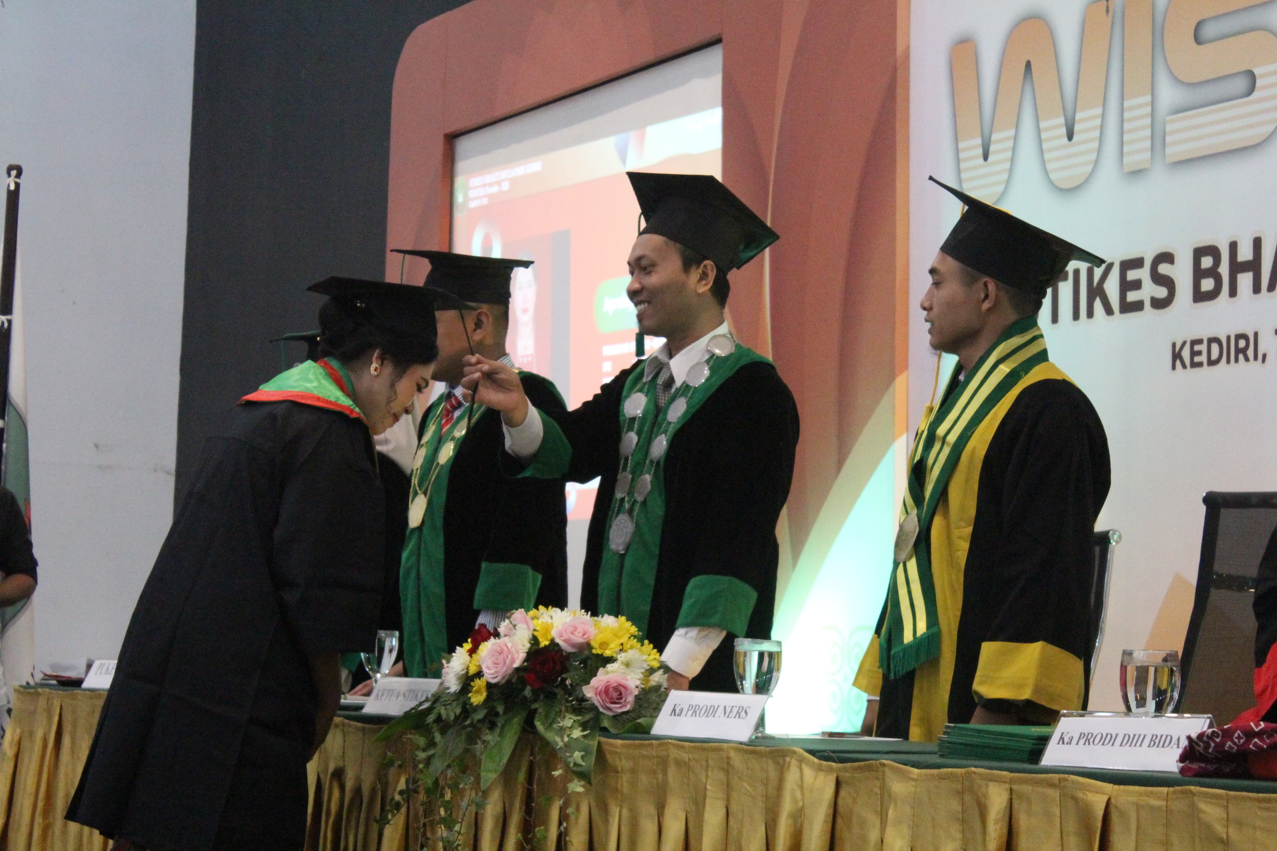 TERBAIK: Ketua STIKes Bhakti Mulia Kediri didampingi jajaran senat kampus secara simbolis memindahkan tali toga sebagai simbol pelepasan lulusan.