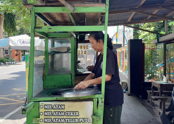 CEKATAN: Pedagang mie ayam sedang melayani pembeli.