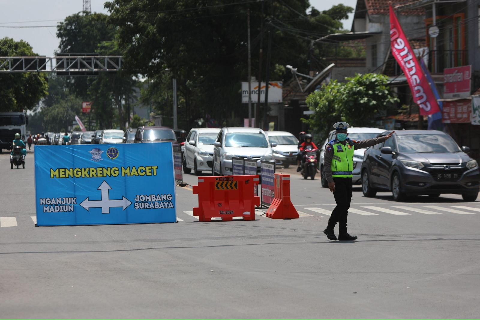 SIBUK: Petugas dari Polres Kediri mengatur lalu lintas di Perempatan Papar, Kabupaten Kediri.