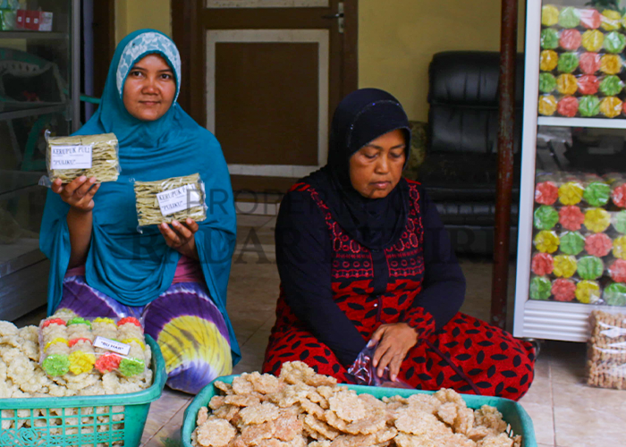 Harmaji (kanan) bersama Putri Wahyuni, menantunya mengemas rengginang untuk dipasarkan.