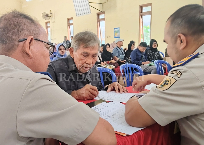 PROGRES SIGNIFIKAN: Warga menandatangani sejumlah berkas dalam pencairan ganti rugi tol di Balai Desa Maron, Banyakan kemarin.