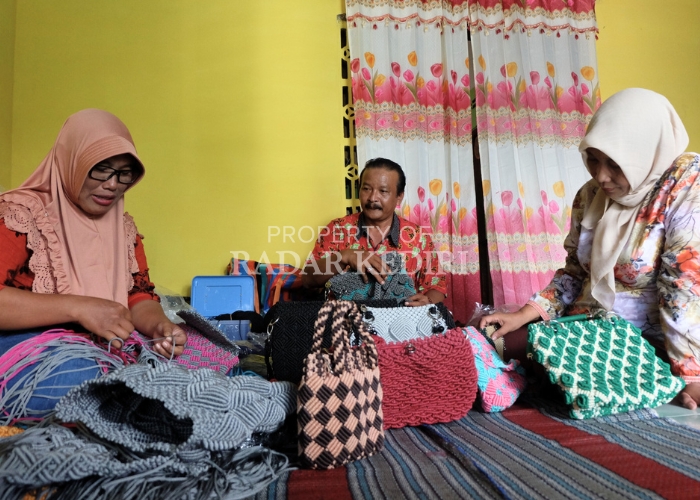 KREATIF: Putianah (kiri), warga Desa Purwodadi, Kecamatan Purwoasri sedang mengerjakan pesanan tas dari tali kur.