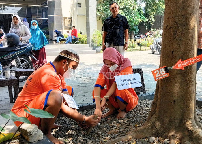 TERBATAS: Mian Tasgeen dan Novita Anggraini melakukan reka adegan dalam kondisi tangan terborgol kemarin.