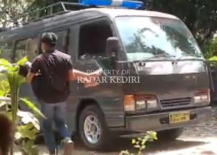 PENYELAMATAN: Petugas mengangkat Samuel, korban perampokan dari dalam rumah.
