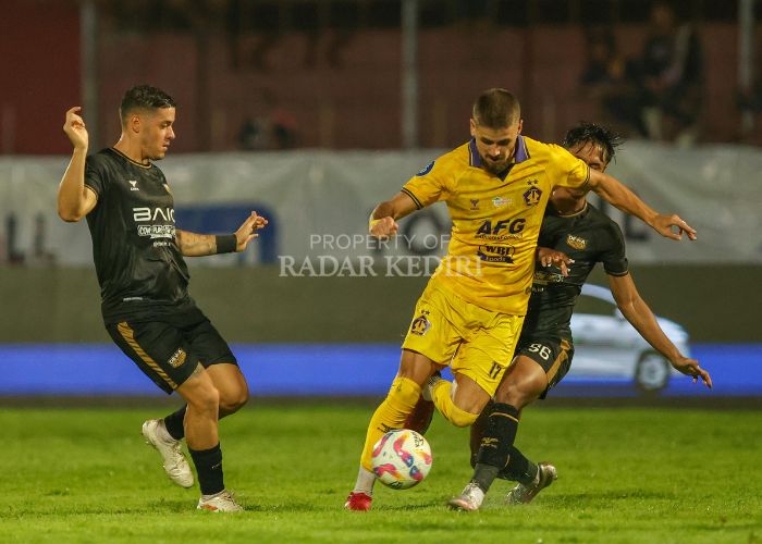 Gelandang serang Persik Kediri Majed Osman melewati hadangan dua pemain Dewa United.