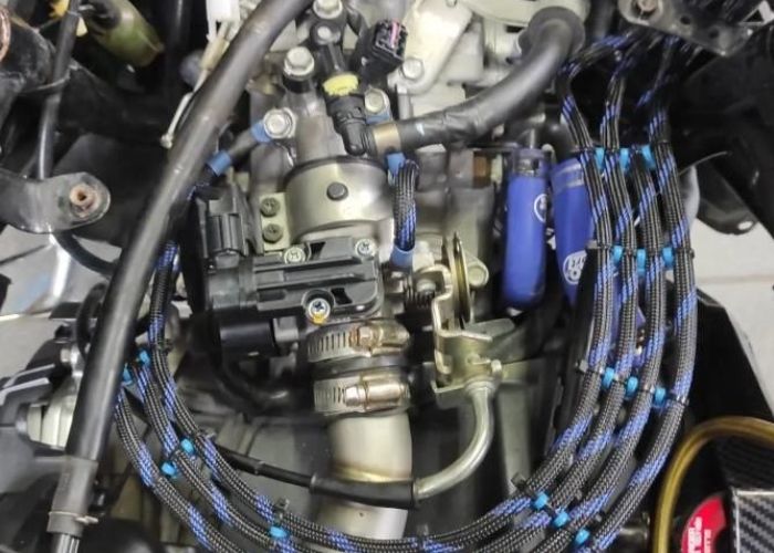Proses pembersihan TB pada motor injeksi agar tarikan kembali enak.