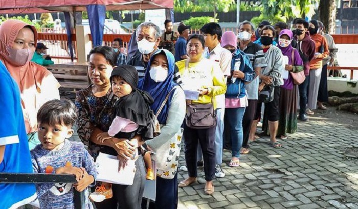 Masyarakat antri mendapat bantuan sosial.