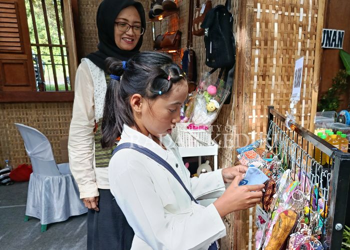 UNIK: Seorang pengunjung sedang melihat aksesoris gantungan kunci.