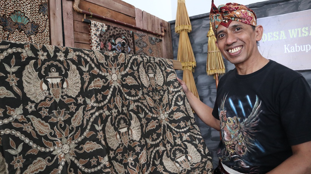 Adi Wahyono menunjukkan batik &lsquo;Padma Loka Moksa&rsquo; yang dipamerkan di Gedung Kesenian dan Museum Kabupaten Kediri kemarin.