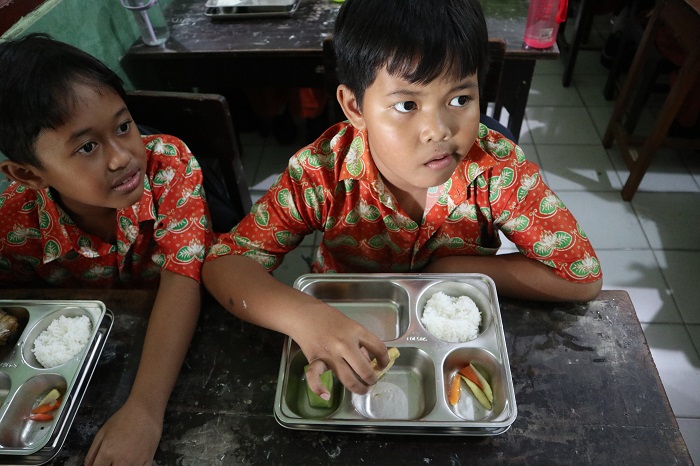 Siswa SDN Bandarkidul 3 menunjukkan paket makan bergizi gratis &ldquo;minimalis&rdquo; berisi lima iris sayur oseng yang diterima kemarin pagi.