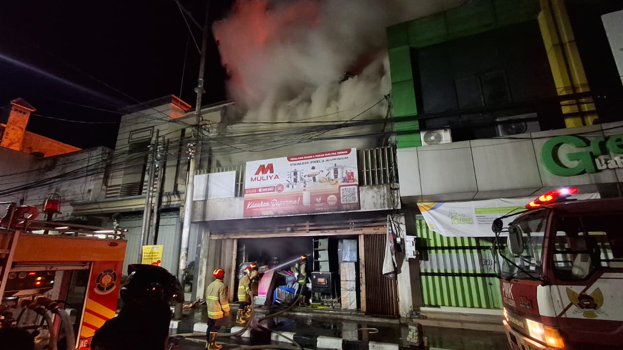 GEMPAR: Petugas damkar berjibaku memadamkan amukan si jago merah.