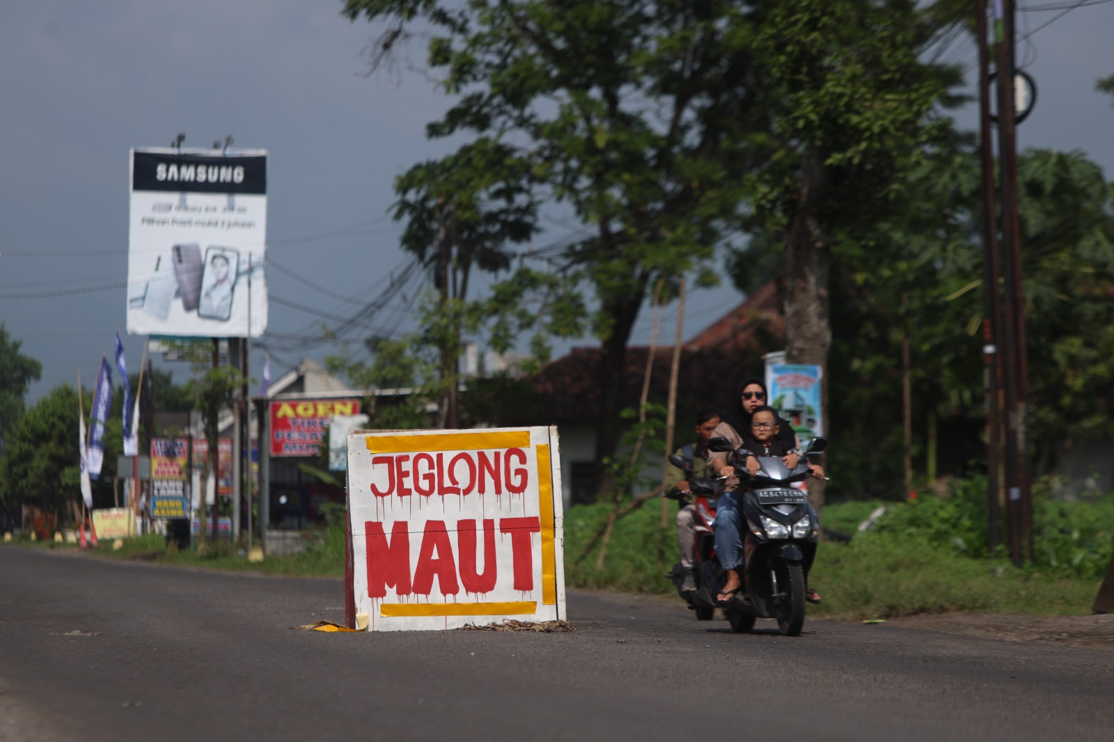 Warga memasang perngatan jeglong maut agar pengendara berhati-hati.