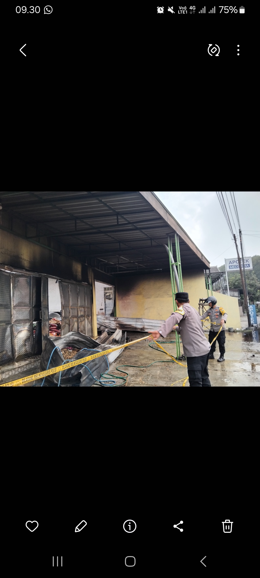 Petugas memasang pita kuning di sekeliling gudang yang terbakar (Diana Yunita/JPRK)
