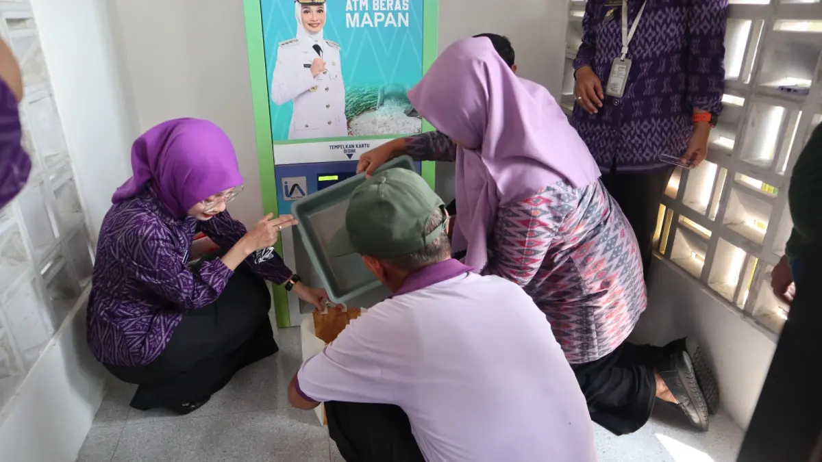 HARUS TEPAT SASARAN: Wali Kota Vinanda Prameswati (kiri) ikut menyerahkan bantuan beras lewat ATM di depan rumah dinasnya untuk warga Kelurahan Pocanan, Kota Kediri, Kamis (16/4). (Foto: Ayu Isma)