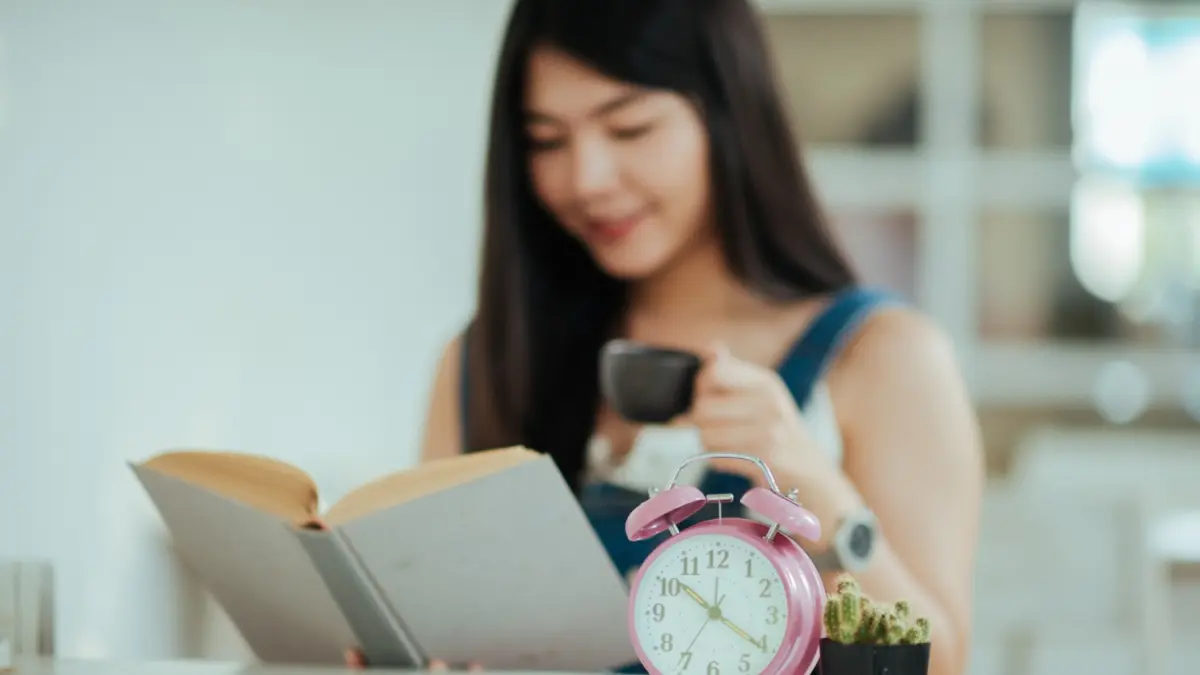 Ilustrasi seseorang belajar dengan buku dan jam sebagai pengingat waktu. Mengatur durasi belajar dapat membantu sesi belajar terasa lebih terstruktur dan memberi ruang untuk beristirahat. Foto: freepik