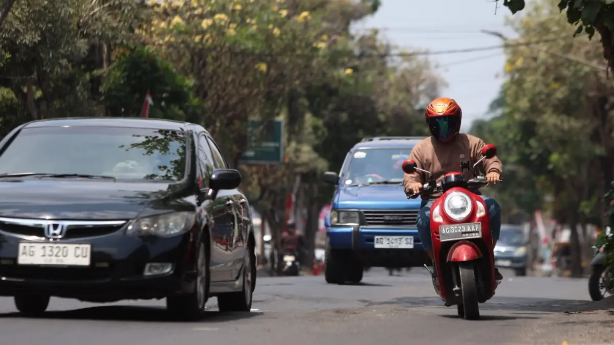 Warga melintas di Jalan MT Haryono yang bergelombang dan berlubang. (Wahyu Adji/JPRK)