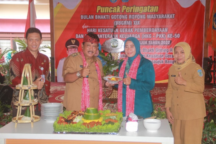 MBANGUN DESO, NOTO KUTHO: Kang Marhaen memotong tumpeng di Puncak Peringatan BBGRM XIX dan HKG PKK Ke-50. Juara 1 lomba bank sampah. (Foto: Andhika Attar)