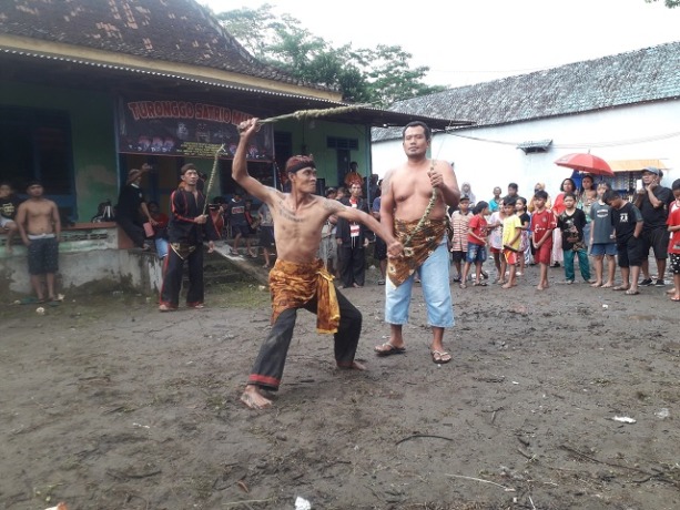 ADILUHUNG: Warga mengikuti tradisi Tiban di Ngadiluwih. Ritual saling memecut ini biasanya digelar pada musim kemarau untuk meminta hujan. (Foto: Ayu Isma)