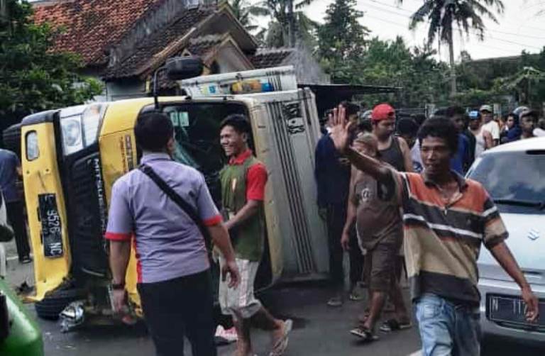 BIKIN MACET: Truk boks L 9526 NC yang disopiri Aris Septianto, warga Kelurahan Mangli, Kaliwates, Jember, terguling di jalan raya Desa Klatakan, Tanggul, Jember, Selasa (4/7).