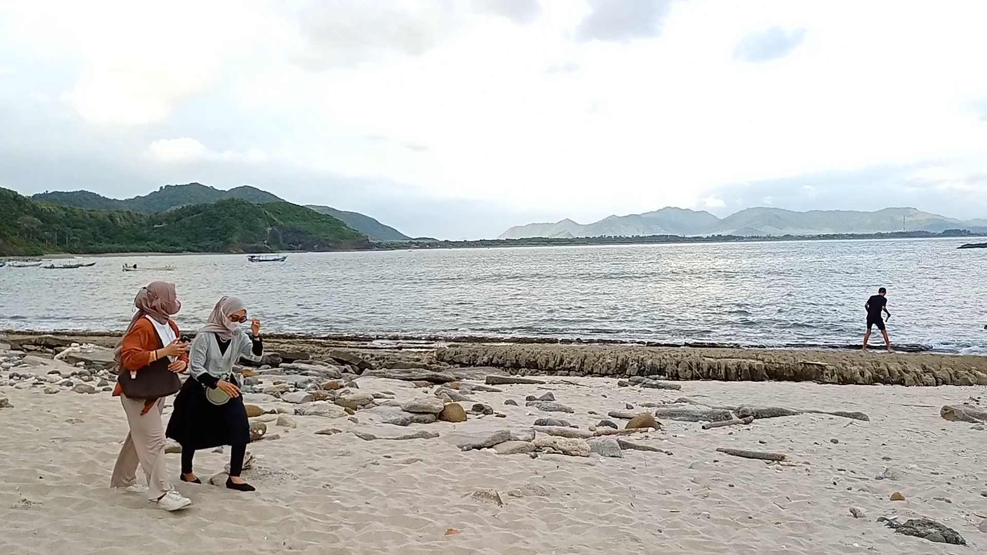 MASIH JADI PRIMADONA: Sejumlah pengunjung ketika berjalan di bibir Pantai Papuma