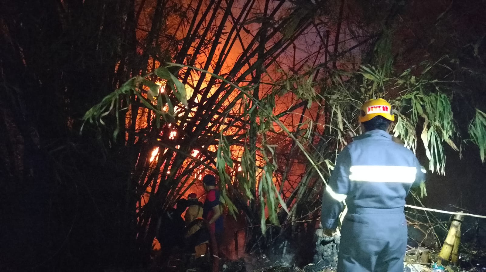 MEMBESAR: Salah satu kebakaran pohon bambu yang diakibatkan bakaran sampah terus meluas mendekati perkampungan