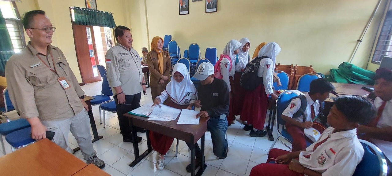 MONEV PPDB: Hadi Mulyono, Kepala Dispendik Jember, didampingi Tulus Wijayano, Plt Kabid Pembinaan SMP, melakukan monev di SMPN 1 Rambipuji. (JUMAI/RJ)