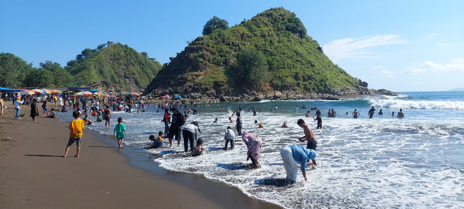 TETAP MANDI: Wisatawan yang datang ke pantai Payangan, Dusun Watu Ulo, Desa Sumberejo, Kecamatan Ambulu masih saja mandi walau ada larangan untuk tidak mandi. (Jumai/ radar jember)