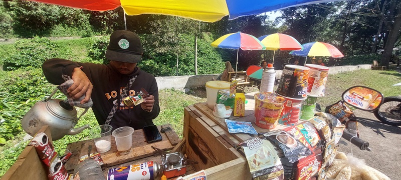 JALAN HIDUP: Rocky Firmansyah, pemuda penjual kopi keliling ini cukup viral berkat pembeli sering mengunggah kawasan tempat ngopi ke media sosial. (JUMAI/RADAR JEMBER)