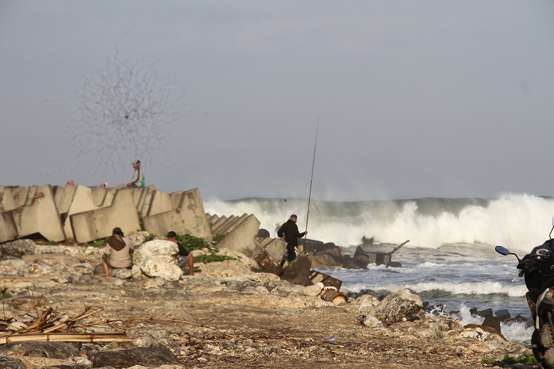 MASIH BESAR: Pemancing yang biasa mancing di breakwater memilih pindah ke lokasi yang lebih aman, karena ombak masih besar.