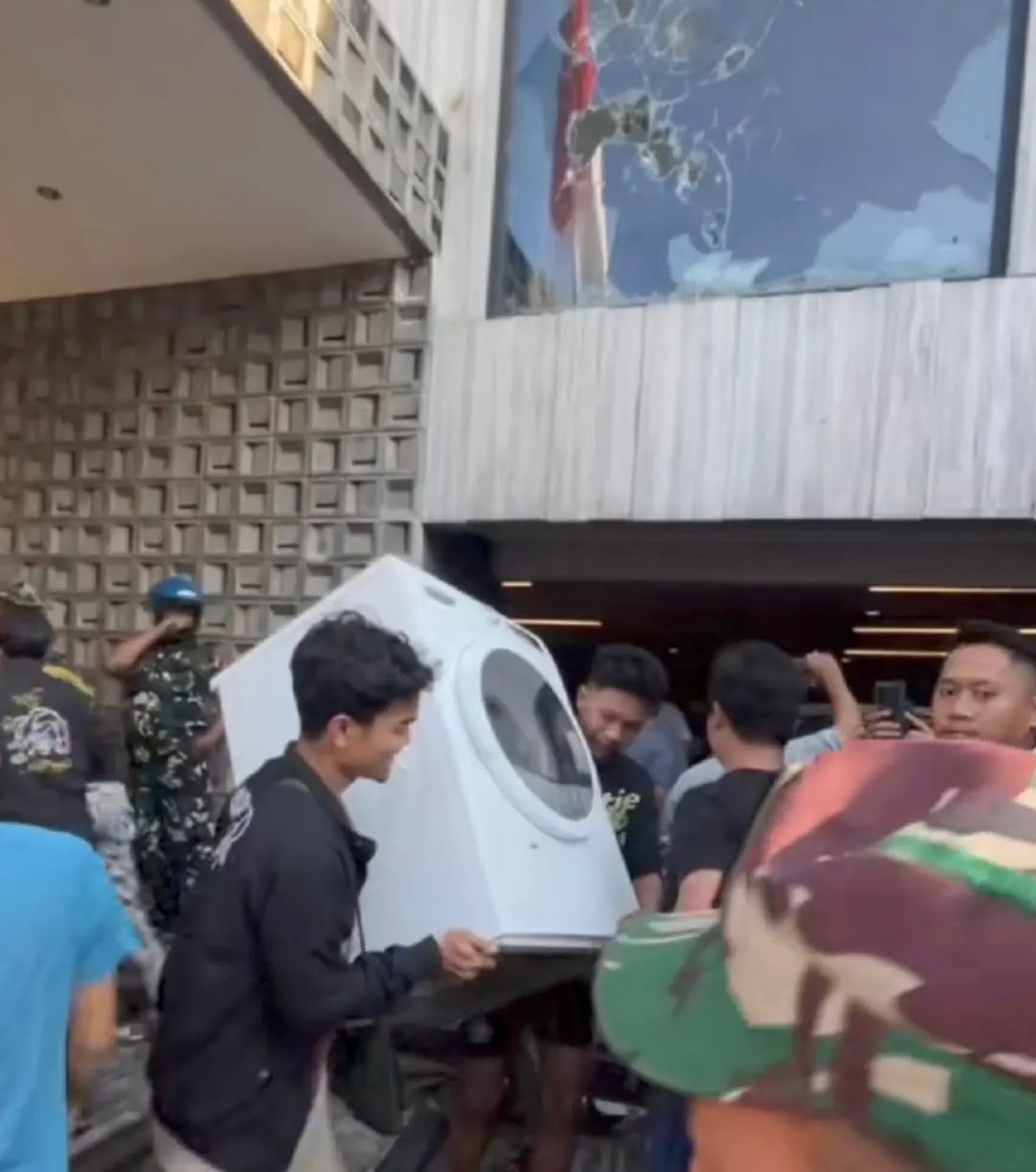 DIJARAH : Sejumlah massa terlihat menjarah barang dari rumah milik Ahmad Sahroni saat kericuhan pecah.
