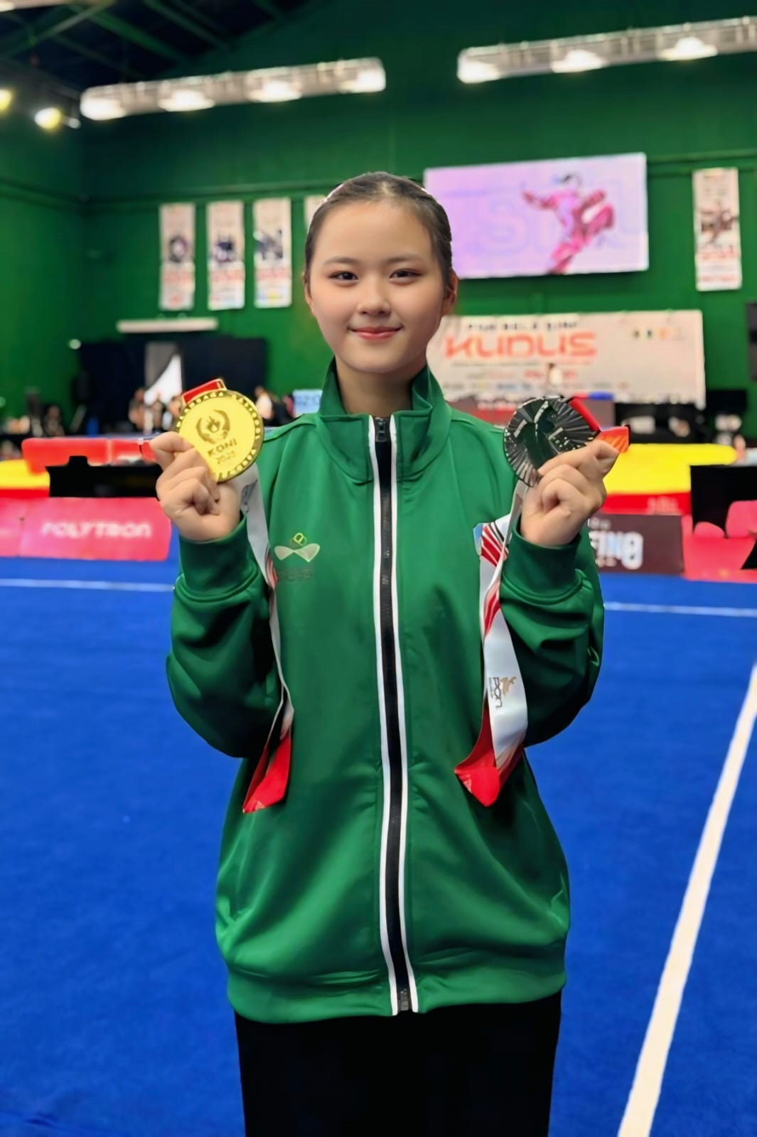 RAIH JUARA: Atlet Wushu Jember, Jessie Djalimin menunjukkan kedua medali yang diraih pada ajang PON Beladiri di Kudus, Sabtu (25/10).