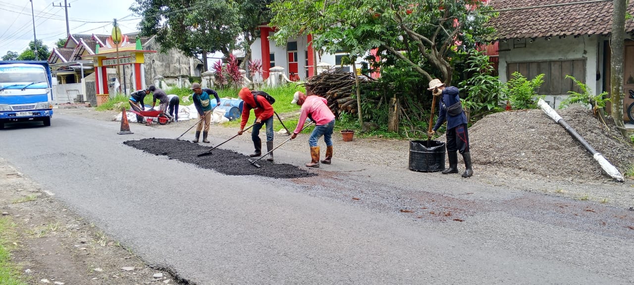 PERBAIKAN JALAN: Tim URC Dinas PU Bina Marga dan SDA Jember saat menambal kerusakan jalan di jalan penghubung Kecamatan Arjasa - Kalisat, (19/11).