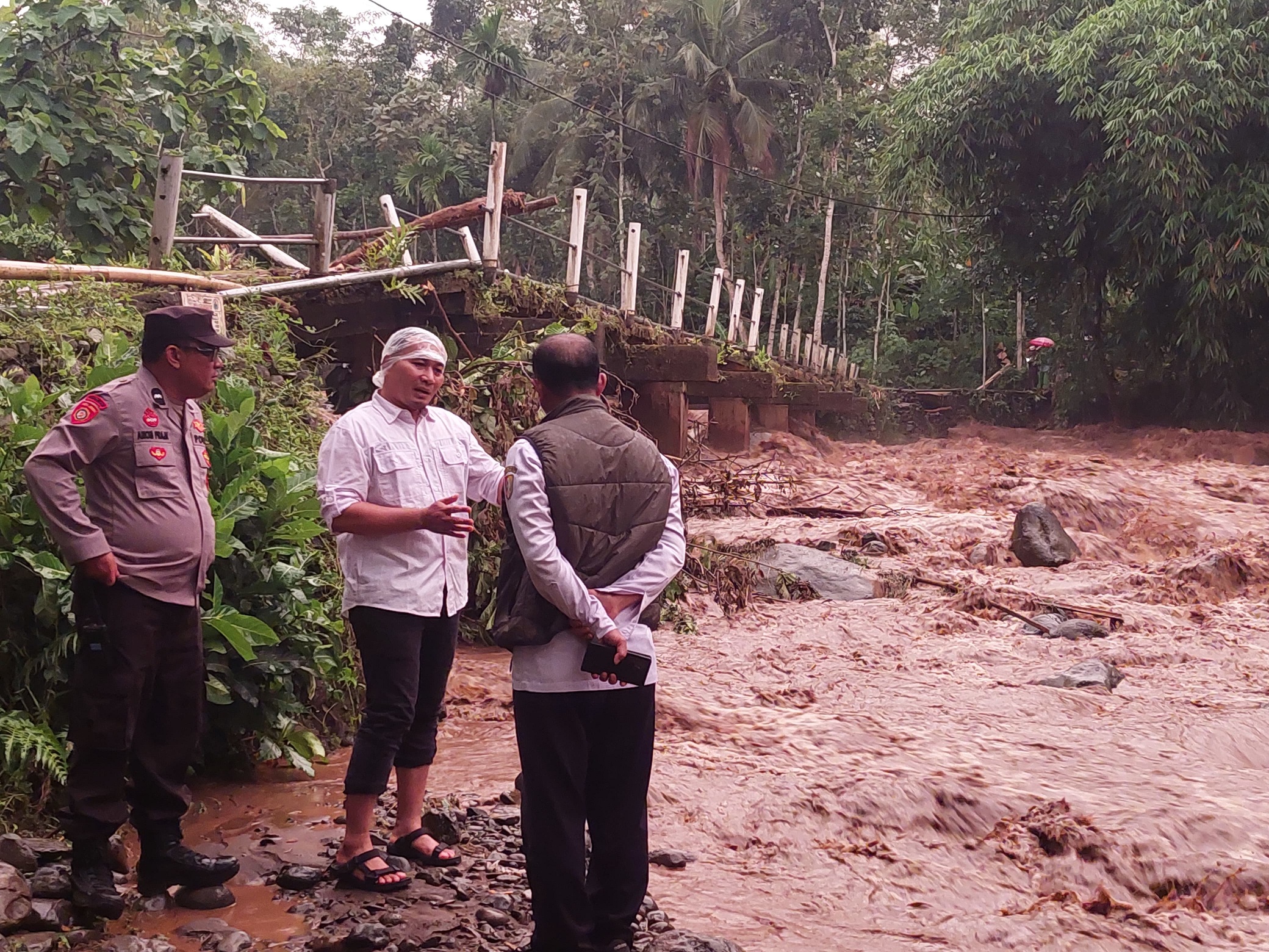 DATANG KE LOKASI: Camat Sumberbaru M Faridj Wadji (tengah), Kanit Intel Polsek Sumberbaru melihat kondisi sungai Genjit di jembatan Desa Karangbayat, Kecamatan Sumberbaru.