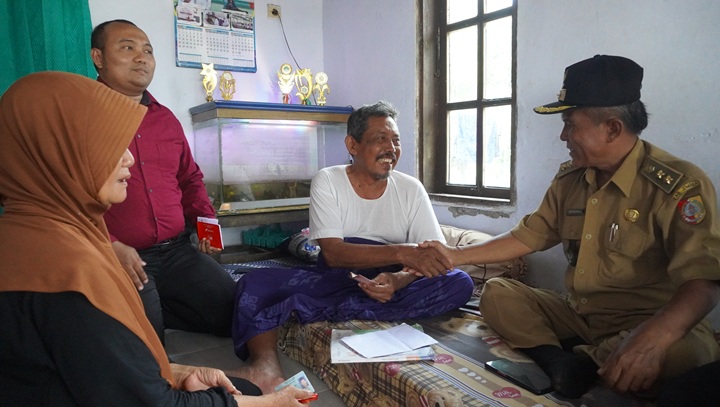 UKIR SENYUMAN: Petugas dari perbankan beserta pemerintah desa saat mendatangi kediaman Kiai Sanusi, tokoh agama penerima program insentif guru ngaji, di Desa Pondokjoyo, Kecamatan Semboro, pada awal O