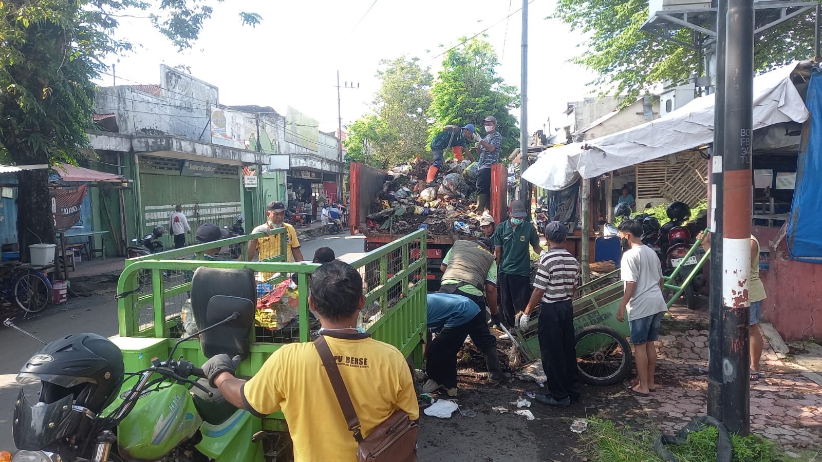 DITERTIBKAN: Petugas gabungan membersihkan rumah warga di Kelurahan Blindungan, pasca bertahun-tahun menjadi tempat penampungan sampah.(ILHAM WAHYUDI/RADAR IJEN)