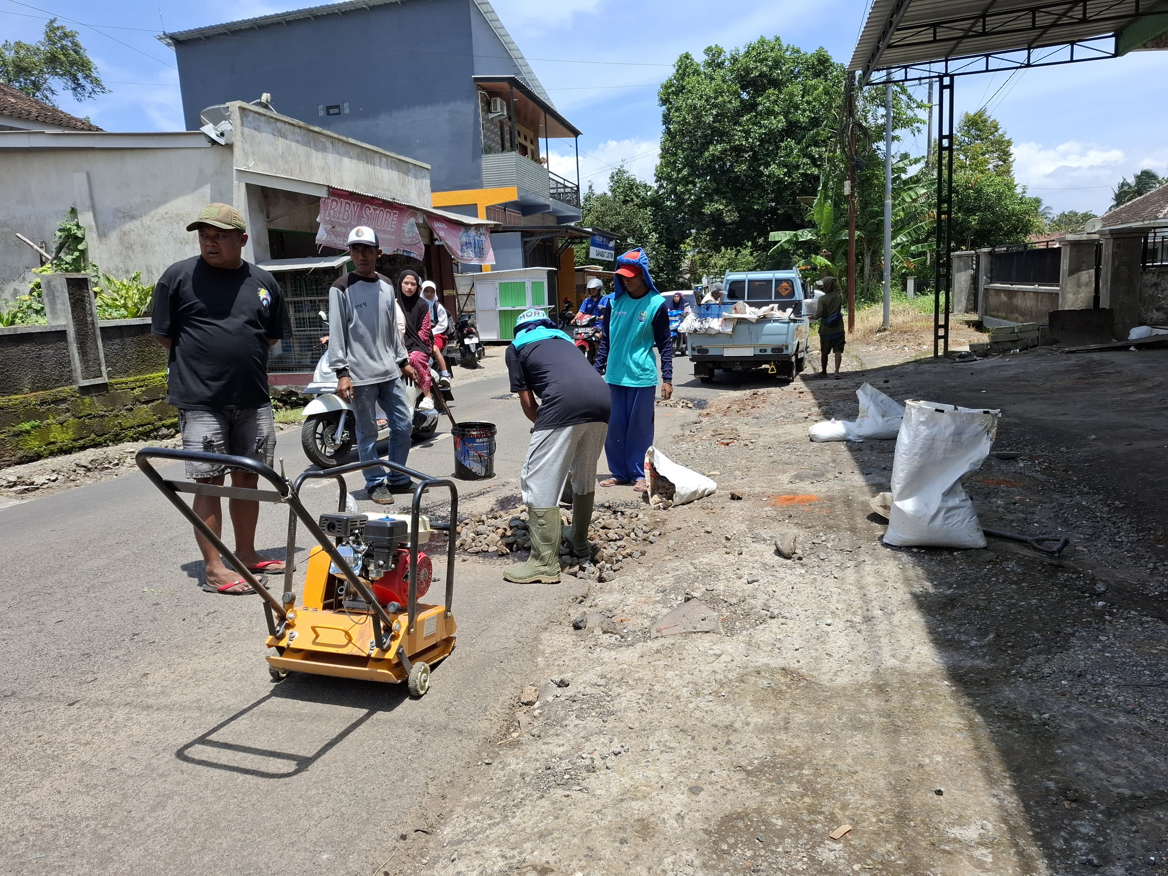 KOMPAK: Sejumlah warga memperbaiki jalan di Pujer, semua dananya berasal dari dana swadaya warga setempat.  