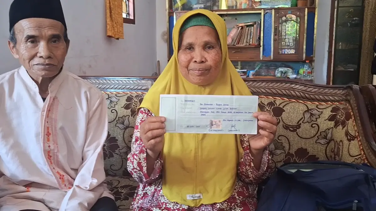 
TUNJUKKAN: Suminten, 72, dan suaminya, Suhari, 74, saat menunjukkan kwitansi palsu yang
diberikan oleh MS.