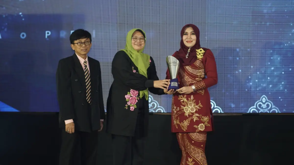 (Kiri) Direktur Jawa Pos Radar Jember, Abdul Choliq Baya, dan Kepala Diskominfo Jatim Sherlita Ratna Dewi Agustin (mewakili Gubernur Jatim), menyerahkan apresiasi penghargaan kepada Anggota DPD RI, Lia Istifhama, dalam ajang Radar Jember Award 2026, di Hotel Fortuna Jember, (20/8). (Dok. Radar Jember)