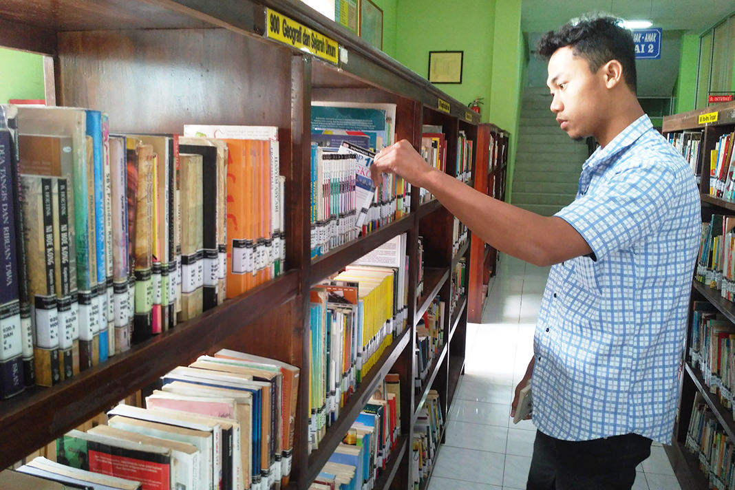 NUR HARIRI/RADAR JEMBER  MANUAL: Seorang pelajar mencari buku di Perpustakaan Jember.