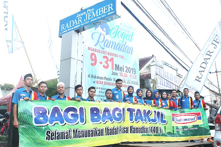 KOMPAK: Karyawan Indomaret bersama Jawa Pos Radar Jember tampak semangat memberikan takjil gratis di depan kantor Jawa Pos Radar Jember