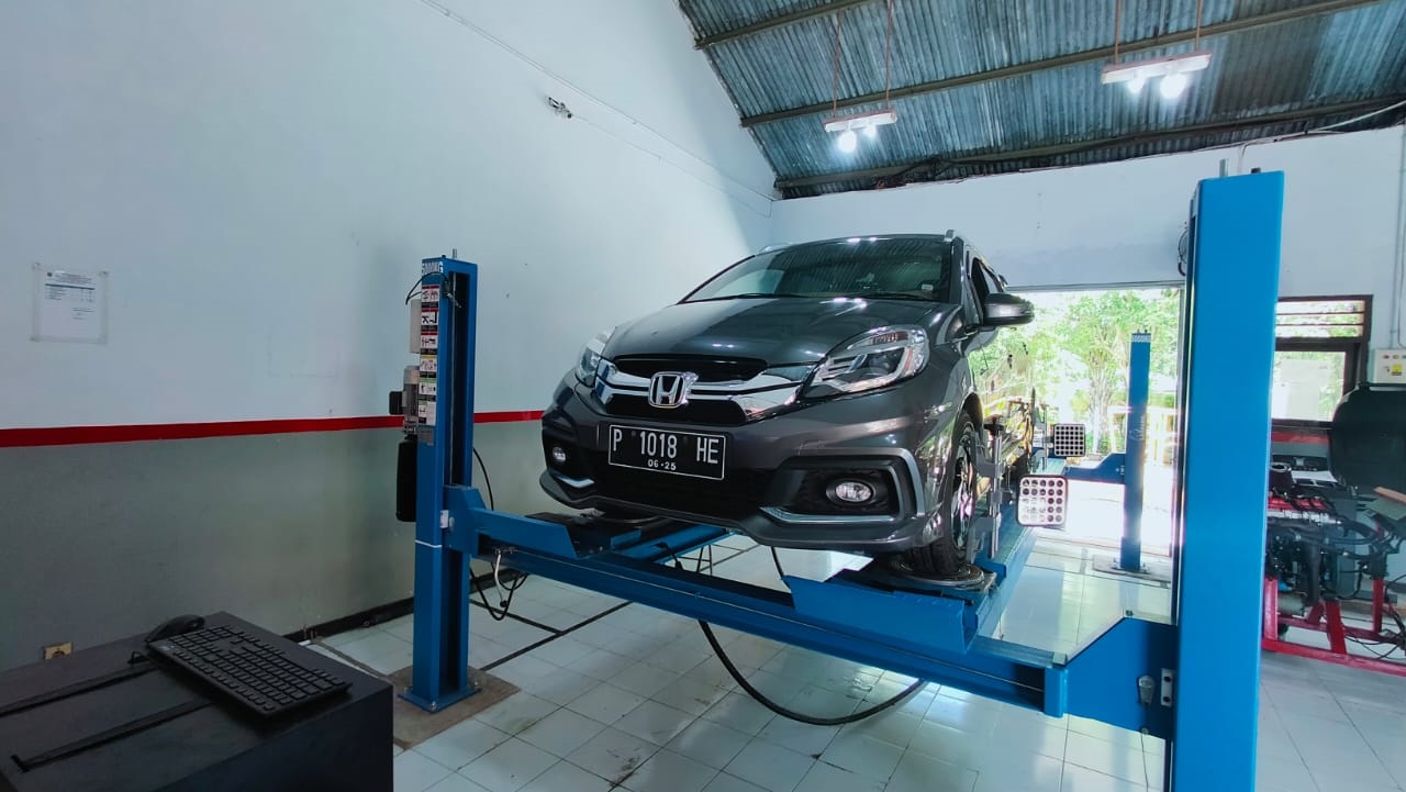 SIAP LAYANI MASYARAKAT: Suasana bengkel mobil yang menjadi bentuk Teaching Factory (Tefa) SMKN 8 Jember. Bengkel mobil yang berada di sekolah tersebut dapat melayani berbagai jenis servis dan tune up hingga spooring dan balancing.