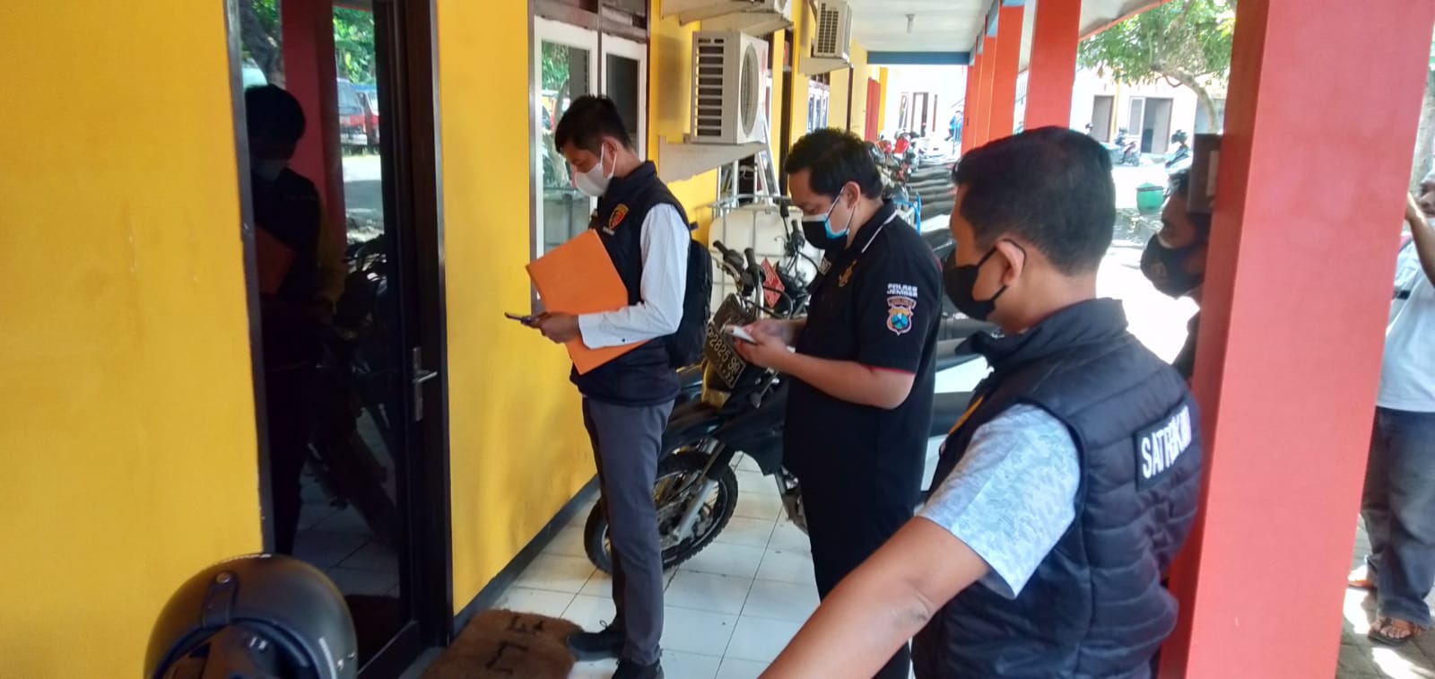 MENUNGGU: Aparat kepolisian sempat terhambat ketika akan masuk ke ruangan Kepala BPBD Jember. Mereka menunggu beberapa saat karena di dalam ruangan sedang ada rapat.
