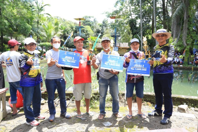 RAIH JUARA: Agus Yuhariadi saat menerima hadiah dari Jawa Pos Radar Jember, yang diberikan langsung oleh Febrian Kahar, pemilik Taman Botani Sukorambi.