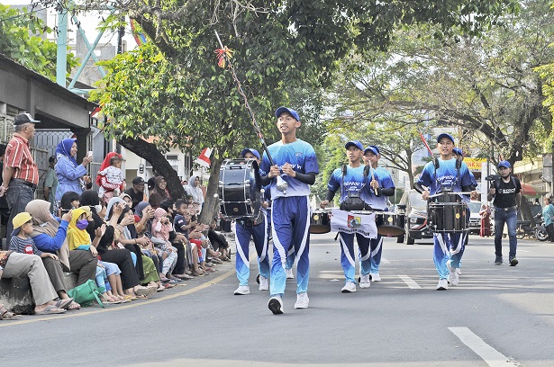 TAMPIL MAKSIMAL: Tim drum band Jember menjadi perhatian warga ketika mengelilingi Jember, kemarin.