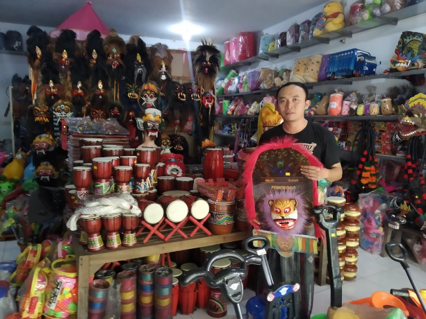 MASIH STABIL: Muhammad Amin, salah seorang penjual topeng kesenian di Desa Baratan, Patrang. Hingga kini penjualannya tidak menurun juga tak meningkat.